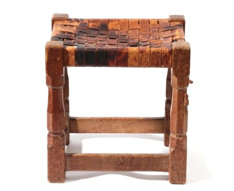 Mouseman: A Robert Thompson of Kilburn English Oak Stool, strap leather top, on four octagonal legs joined by stretchers, wit