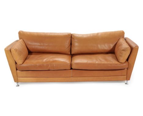 A 1970's Danish Stouby Three-Seater Sofa, upholstered in natural tan leather, eight cushions, 215cm by 89cm by 87cm