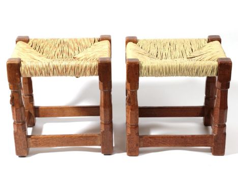 Mouseman: Two Robert Thompson of Kilburn English Oak Stools, on four octagonal legs joined by stretchers, with carved mouse s