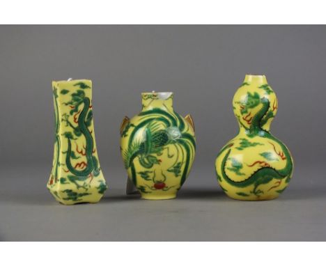 A set of three Fukagawa vases, early 20th Century, each decorated with dragons and phoenix birds in green enamel against a ye