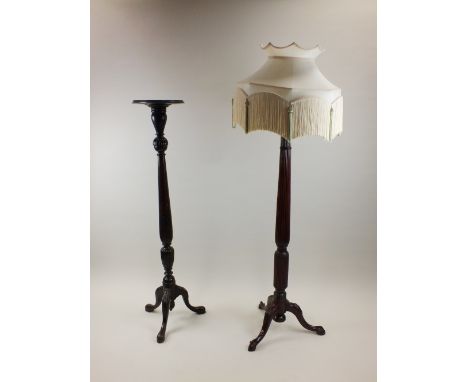 An Edwardian mahogany torchere stand with dished top and foliate lappetted pilaster column on three foliate carved down curve