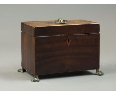A George III mahogany and inlaid tea caddy, early 19th century, lacking divisions, with lion mask ring handle and on brass pa