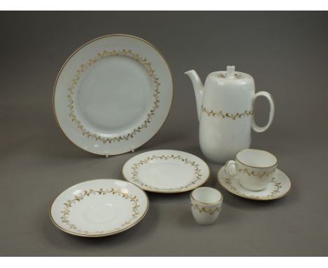 A comprehensive Royal Worcester tea, coffee and dinner service, sparsely decorated with gilt.