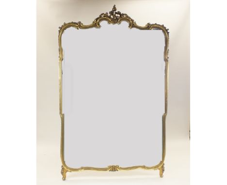 A large Rococo style gilt framed wall mirror, first half 20th century, the shaped plate within a foliate scroll border on sha