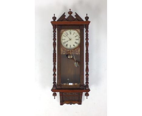 A walnut style Vienna style wall clock, late 19th century with architectural pediment, 8 inch painted dial with Roman numeral
