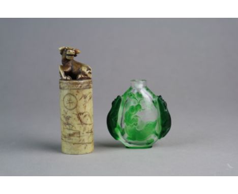 A Chinese cameo glass snuff bottle19th/20th CenturyThe clear glass cased in green and carved with twin dog handles, one side 