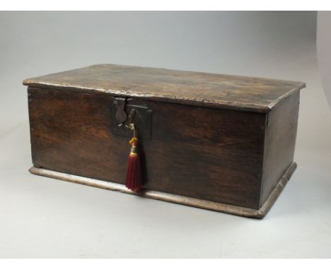 An oak deed or bible box, 17th century , the rectangular top with simple wood hinge enclosing a single shelf, ironwork clasp 