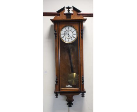 A Vienna style regulator wall clock, 19th century, in walnut and ebonised frame with architectural pediment above an arched g