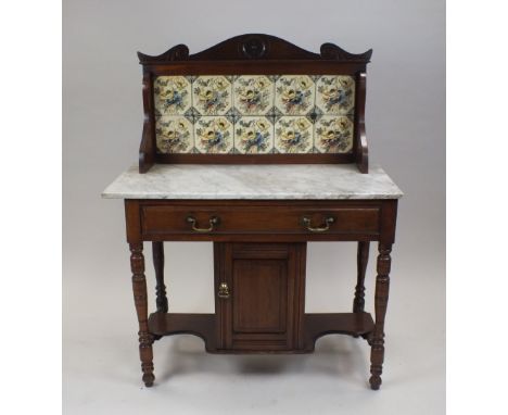 A late Victorian walnut marble topped wash stand with printed and coloured floral tile splash back, above a frieze drawer and