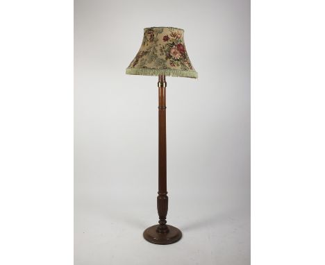 An early 20th century oak fluted standard lamp on turned circular base and with cream floral shade, 172cm high