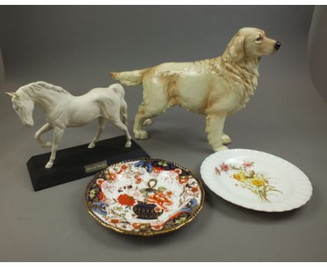 A large Goebel model of a Golden Retriever, 29cm high, a Beswick model of Spirit of Freedom, and two Royal Crown Derby plates