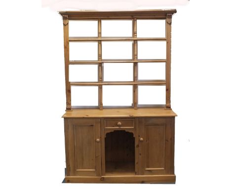 A modern pine 'dog kennel' kitchen dresser with open three height delft rack above a rectangular top and short drawer and rec