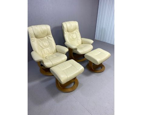 Pair of cream upholstered Lazyboy reclining armchairs, with matching footstalls on light wood bases 