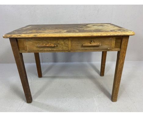 Oak desk with two drawers, wooden handles and square legs, approx 107cm x 61cm x 77cm 
