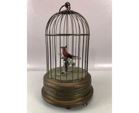 Victorian 20th Century bird cage automaton, with a clockwork mechanism operating red feathered bird which moves and sings bea