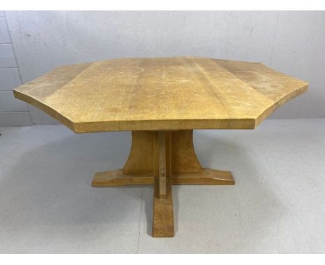 Workshop of Robert Mouseman Thompson: An English oak octagonal dining table, on a cruciform base, with characteristic carved 