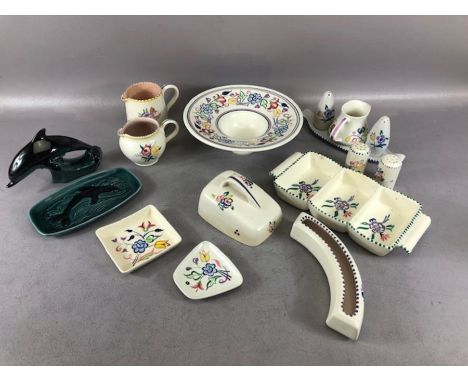 Collection of mostly Poole Pottery to include, two jugs, two condiment sets, wide-rimmed bowl, pin dishes, figure of a dolphi