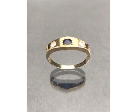 9ct Gold ring set with a blue sapphire in a star shaped mount with two Diamonds to either side approx size 'K' and 1.6g