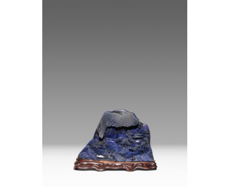 A CHINESE LAPIS LAZULI BOULDER CARVING QING DYNASTY One side carved in relief with two scholars and an attendant crossing a b