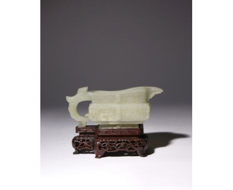 A CHINESE CELADON JADE ARCHAISTIC POURING VESSEL, YI 17TH CENTURY The rectangular body supported on a short flared foot, with