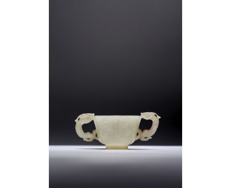 A CHINESE PALE CELADON JADE 'CHILONG' CUP 17TH CENTURY Carved with two shou characters amidst flowerheads and scrolling folia