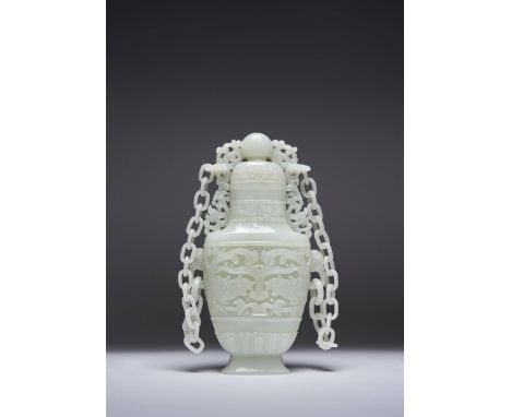 A LARGE CHINESE PALE CELADON JADE VASE AND COVER LATE QING DYNASTY/REPUBLIC PERIOD Of flattened baluster form, carved to each