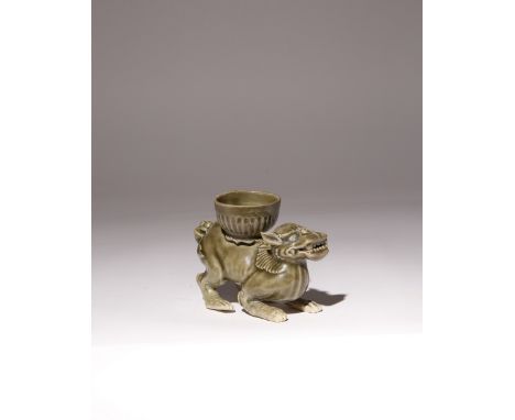 A CHINESE CELADON OIL LAMP C.12TH CENTURY Modelled as a crouching mythical beast, with its head slightly raised, and carrying