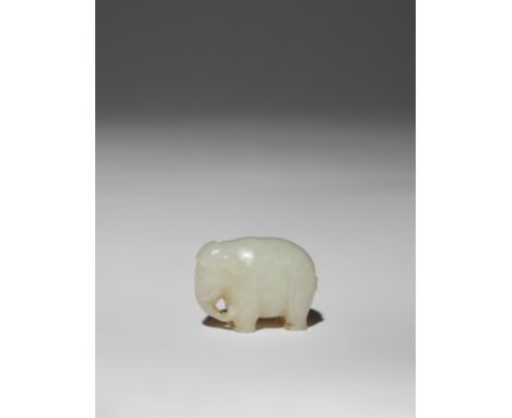 A SMALL CHINESE WHITE JADE CARVING OF AN ELEPHANT QING DYNASTY The pachyderm stands four-square with his trunk and tail turne