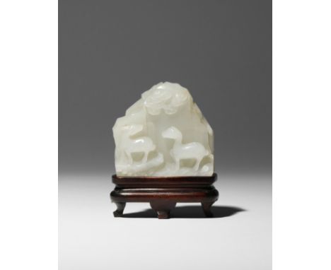 A SMALL CHINESE WHITE JADE 'MOUNTAIN' CARVING QIANLONG 1736-95 Formed as a rocky cliff face, carved in relief to one side wit