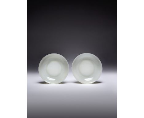 A RARE PAIR OF LARGE CHINESE WHITE JADE DISHES QIANLONG/JIAQING PERIOD Each raised on a straight foot, the shallow, rounded s