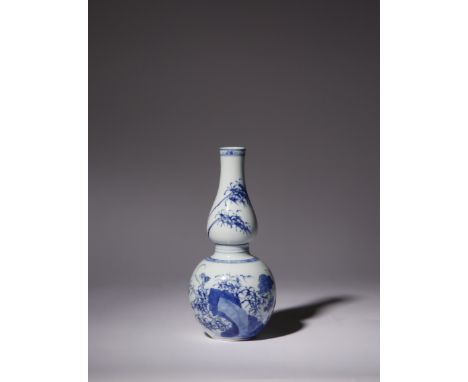 A CHINESE BLUE AND WHITE DOUBLE-GOURD VASE KANGXI 1662-1722 The lower bulb decorated with rose blooms and bamboo emerging fro