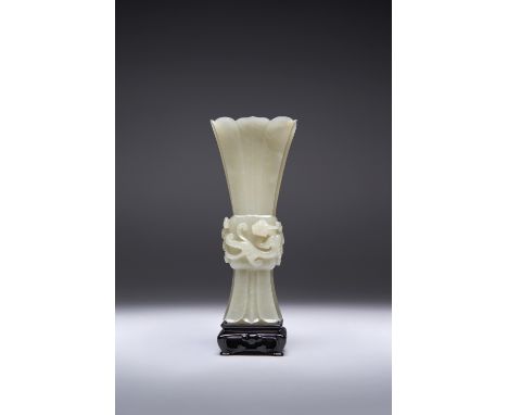 A CHINESE PALE CELADON JADE ARCHAISTIC 'CHILONG' VASE, GU QIANLONG 1736-95 Raised upon a square foot, finely carved with over