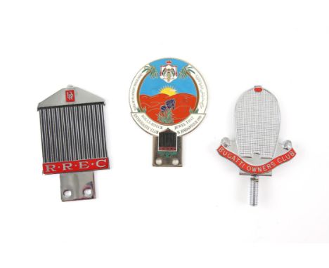 Three vehicle front grill badges - includes Bugatti Owners Club badge in the shape of a front grill, one Rolls-Royce Enthusia