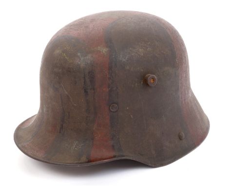 First World War Imperial German M.15 steel helmet, retaining much of original camouflage paintwork and remnants of lining and