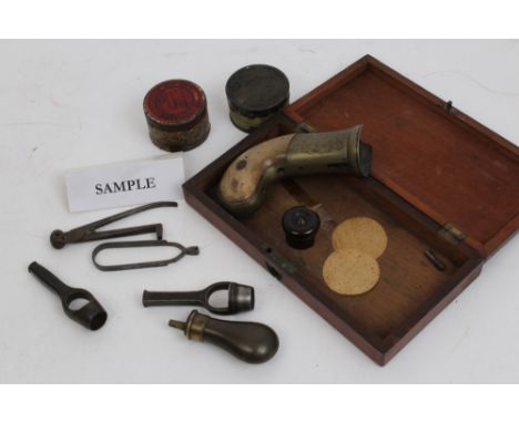 Collection of 19th century gun accessories - including pistol flask, bullet mould, wadcutters, percussion caps and pepperbox 