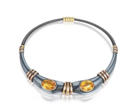 Crafted out of antiqued silver with 18K yellow gold accents, featuring two oval-shaped citrines; inner circumference measures