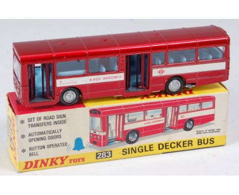 A Dinky toys No. 283 single decker bus comprising metallic red body with blue interior and white base plate in the original a