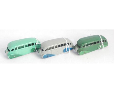 A Dinky Toys No. 29B Streamlined Bus Group, three examples to include light soap green and dark green version, dark green and