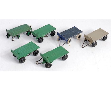 Six various loose Dinky Toys trailers, examples to include No. 25G, pre-war trailer finished in blue with black hubs, No. 429