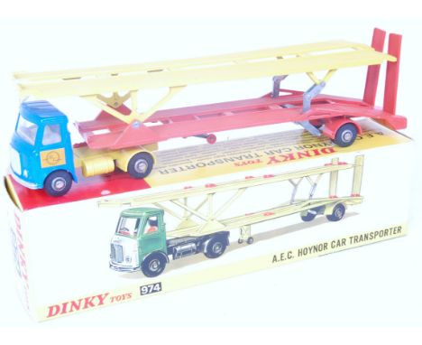 A Dinky toys No. 974 AEC Hoynor car transporter, comprising metallic blue and yellow tractor unit with orange and yellow trai