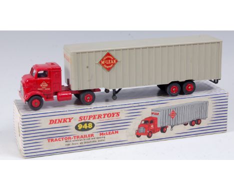 A Dinky Toys No. 948 Mclean tractor and trailer comprising red cab with light grey trailer, red plastic hubs, with both rear 