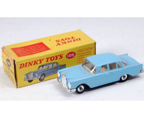 A Dinky Toys No. 186 Mercedes Benz 220SE comprising light blue body with off-white interior and spun hubs, in the original al