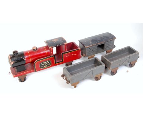 A circa 1910 Lines Brothers wooden carpet train and three wagons, comprising red handpainted LMS four wheel tank loco with tw