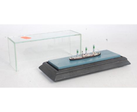 A 1/1200 scale wooden kit built model of a German three funnel steamboat, all housed in wooden and glazed display case