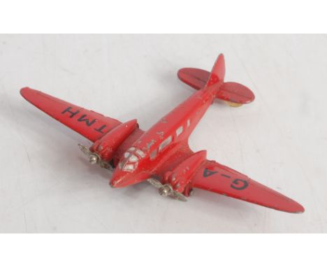 A Dinky Toys No. 62M light transport plane finished in red with G-AMH livery, with twin blade propellers, loose example 