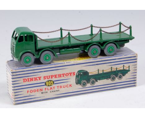 A Dinky Toys No. 905 Foden flat truck with chains, green body with light green hubs and grey wheels in the original blue & wh