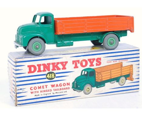 A Dinky Toys No. 418 Commer wagon with hinged tailboard comprising dark green body, light green hubs, and orange back in orig