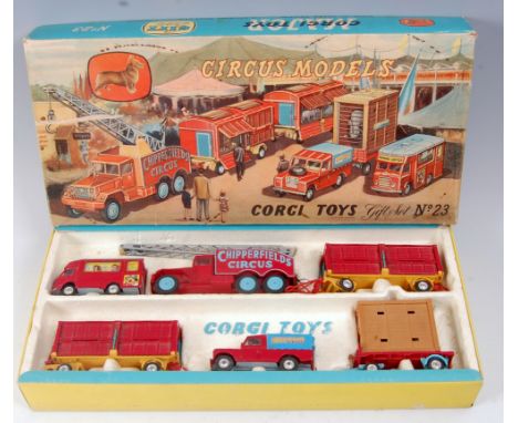 A Corgi Toys Gift Set No. 23 Chipperfields Circus comprising booking van, circus crane truck, two animal cage wagons, LandRov