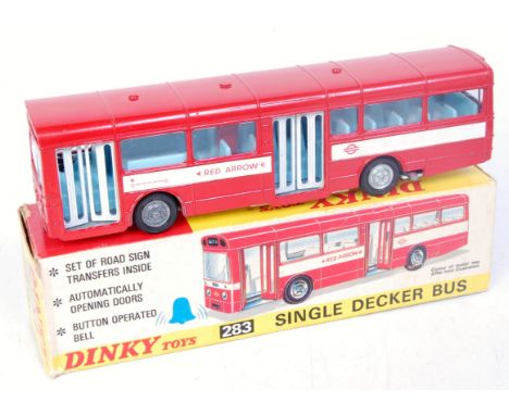 A Dinky Toys No. 283 single decker bus comprising red body with blue interior, white painted base with detailed cast hubs, in