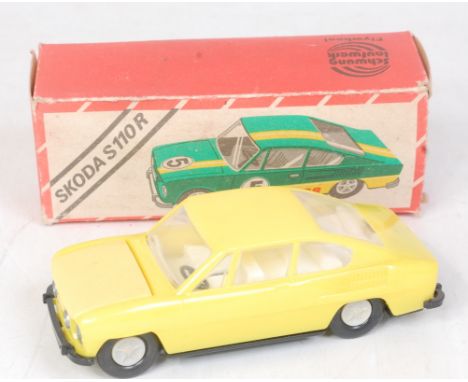 A 1970s East German 1/30 scale plastic friction drive saloon Skoda S110R yellow plastic body with black base plate and grey h
